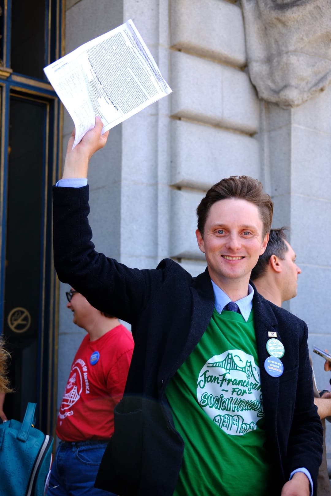 Honest Charley Bodkin holding a petition, wearing a San Franciscans for Social Housing t-shirt